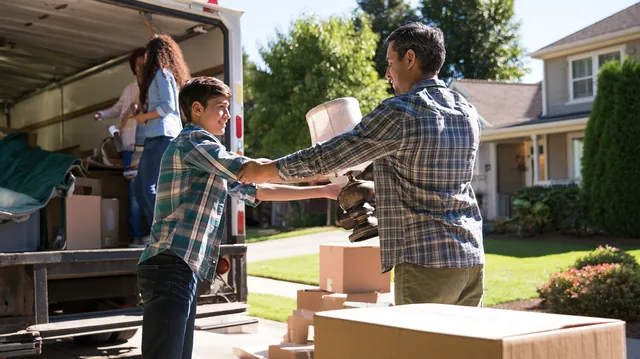 Family loading a rental moving truck in a suburban driveway, the kind of move a $3,000 loan can help cover